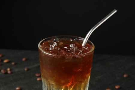 Refreshing espresso tonic drink on dark background, closeup