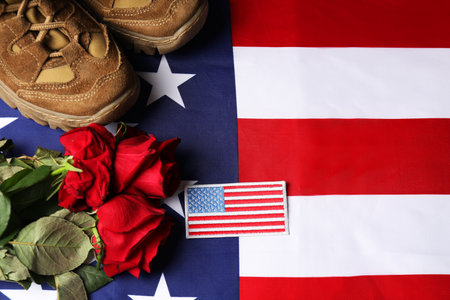 Veterans day. USA army patch, American flag, roses and military shoes, flat layの写真素材