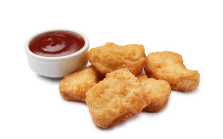 Delicious chicken nuggets with ketchup isolated on whiteの写真素材