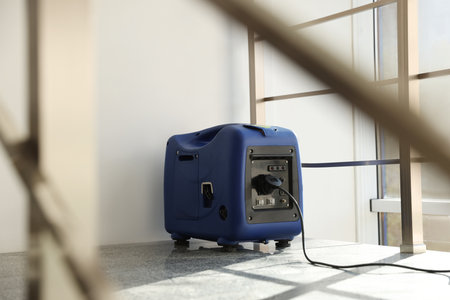 Modern portable power station on floor indoorsの写真素材