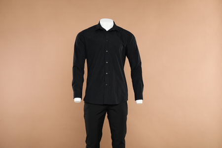 Male mannequin with stylish outfit on light brown backgroundの写真素材