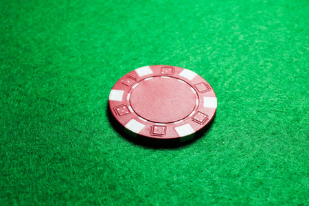 One poker chip on green table, closeupの写真素材