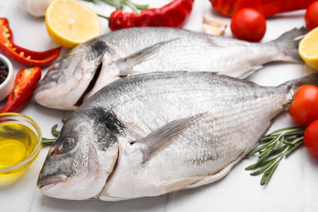 Seafood. Fresh raw fish and products on white tiled table, closeupの写真素材