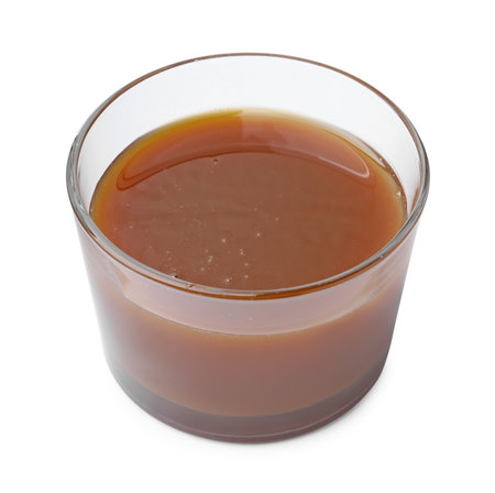 Tasty caramel sauce in glass bowl isolated on whiteの写真素材