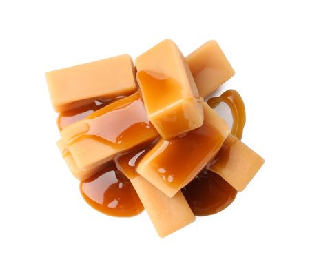 Tasty candies with caramel sauce isolated on white, top viewの写真素材