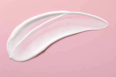 Cream on pink background, top view. Sample of cosmetic productの写真素材