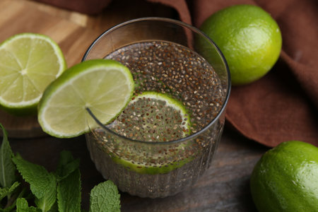 Glass of drink with chia seeds and lime on wooden table, closeupの写真素材
