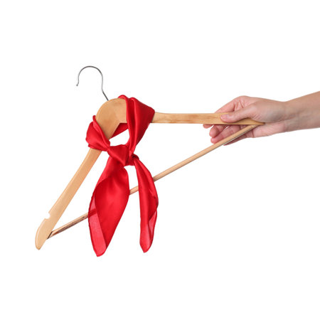 Woman holding hanger with red handkerchief on white background, closeupの写真素材