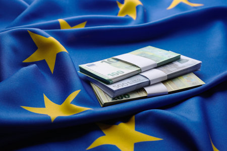 Bundles of euro banknotes on European Union flagの写真素材