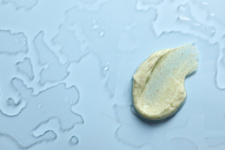 Smear of body scrub on light background, top view. Space for textの写真素材