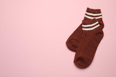 Pair of soft socks on pink background, top view. Space for textの写真素材