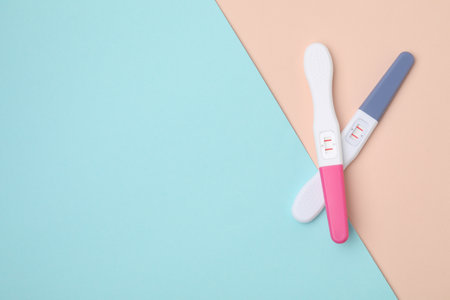 Two pregnancy tests on color background, top view. Space for textの写真素材