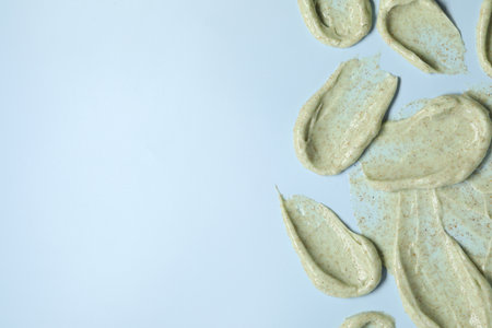 Smears of body scrub on light background, flat lay. Space for textの写真素材