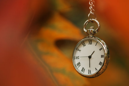 Autumn time. Chain watch on blurred background, closeup with space for textの写真素材