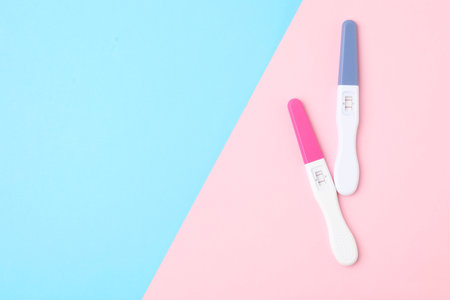 Two pregnancy tests on color background, top view. Space for textの写真素材