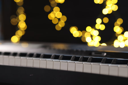 Piano against blurred lights, closeup. Bokeh effectの写真素材