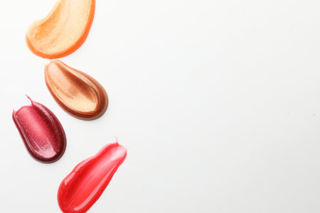 Smears of different lip products on white background, top viewの写真素材