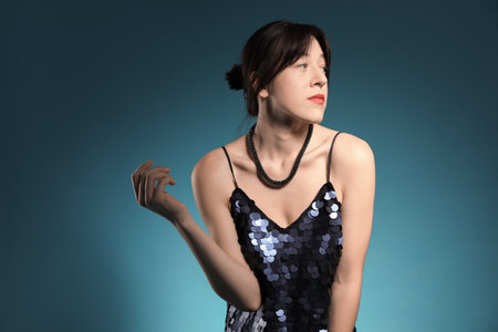 Beautiful young woman posing on blue background