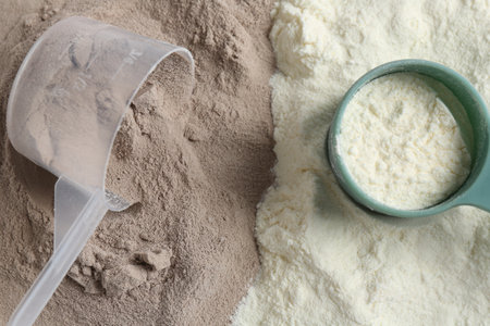 Pile of protein powders and scoops, flat layの写真素材