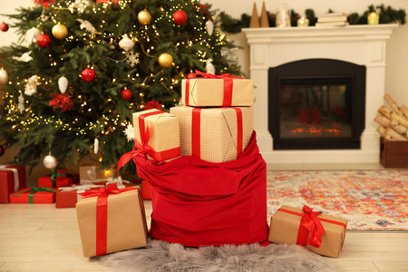 Santa bag full of Christmas presents at homeの写真素材