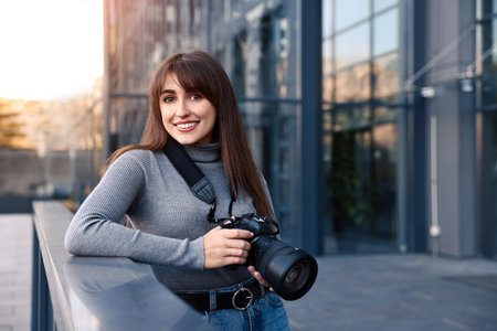 Professional photographer with digital camera near building outdoors