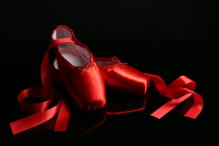 Pair of beautiful pointe shoes on black mirror surfaceの写真素材