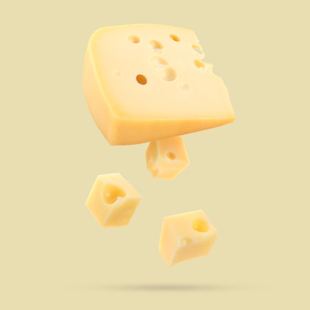 Piece of fresh cheese falling on dark beige backgroundの写真素材