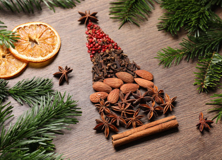 Christmas tree made of different spices, dried orange slices and fir branches on wooden tableの写真素材