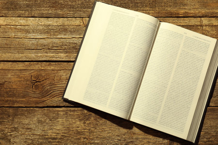 Open Holy Bible in English language on wooden table, top viewの写真素材