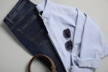 Stylish clothes and accessories on light gray background, flat layの写真素材