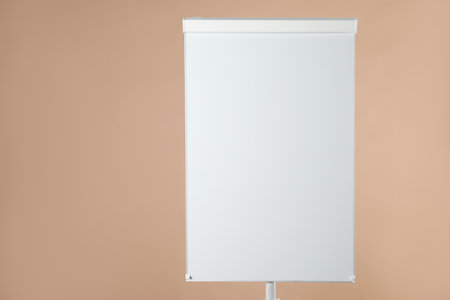 Flip chart on pale brown background. Mockup for designの写真素材