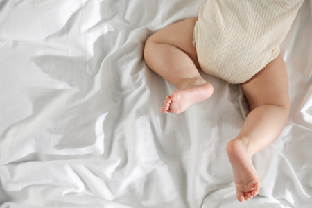 Cute little baby on bed indoors, top view. Space for text