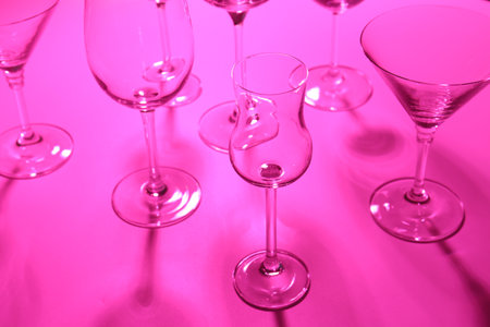 Empty glasses on pink background, closeup. Color tone effectの写真素材