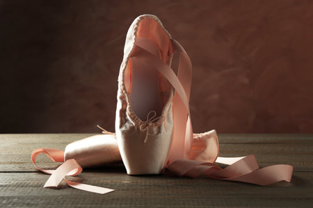 Pair of beautiful pointe shoes on wooden tableの写真素材