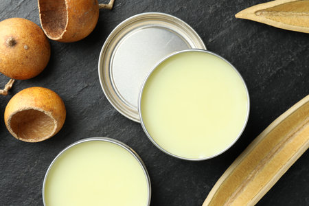 Natural solid perfume and dry fruit peels on black table, top viewの写真素材