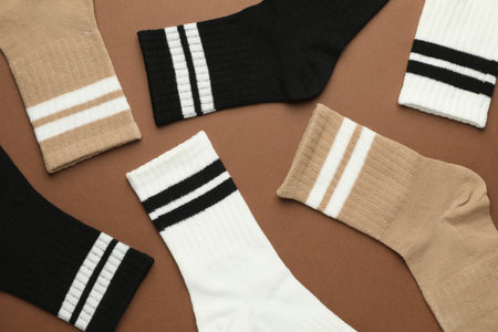 Different soft socks on light brown background, flat layの写真素材