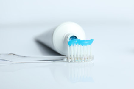 Toothbrush with toothpaste and tube on white background, closeupの写真素材