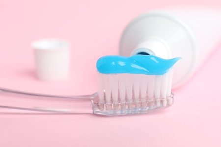 Toothbrush with toothpaste and tube on pink background, closeupの写真素材