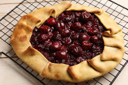 Tasty galette with cherries on wooden table, closeupの写真素材