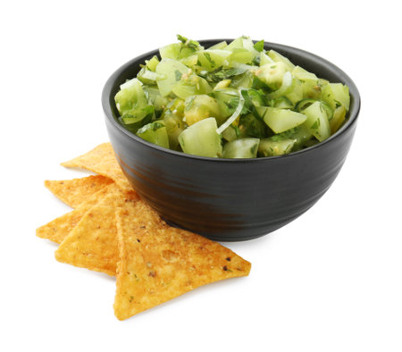 Delicious homemade green salsa with nachos isolated on whiteの写真素材