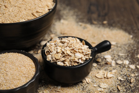 Oat bran and flakes on table, closeup