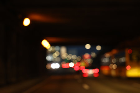 Blurred view of cityscape with road traffic and street lights at nightの写真素材
