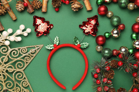 Stylish party headband and Christmas decor on green background, flat layの写真素材