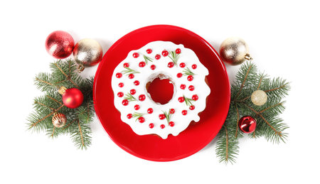 Beautifully decorated Christmas cake, fir branches and baubles on white background, top viewの写真素材