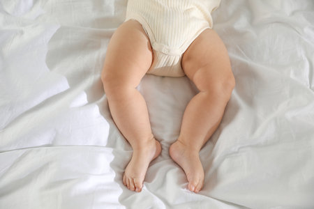 Cute little baby on bed indoors, top viewの写真素材