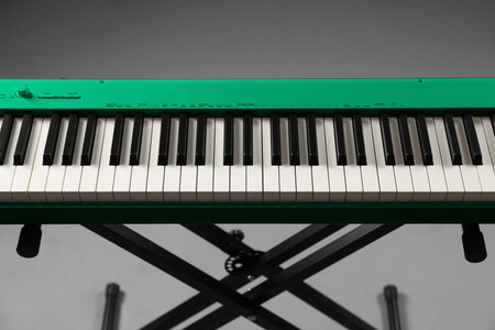 Green and white color keyboard on gray background. Electronic musical instrumentの写真素材
