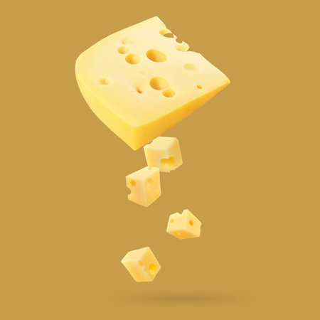Piece of fresh cheese falling on goldenrod color backgroundの写真素材