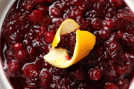 Tasty cranberry sauce and orange zest in bowl, closeupの写真素材