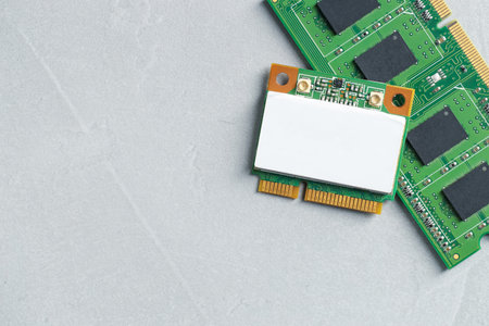 Wi-Fi card and RAM chip on gray table, top view. Space for textの写真素材