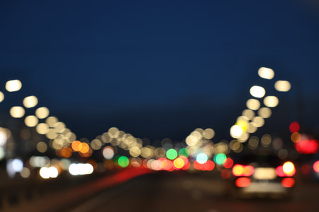 Blurred view of cityscape with road traffic and street lights in eveningの写真素材